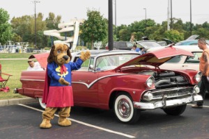 dollar dog in front of red classic car