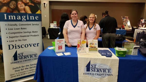 First Service promotional table with two employees