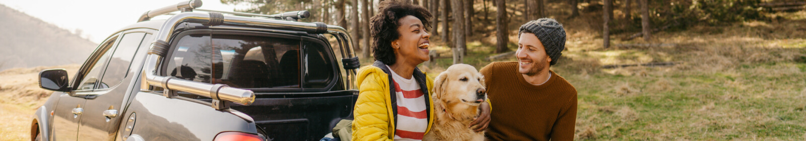 Young couple and a dog in the wilderness