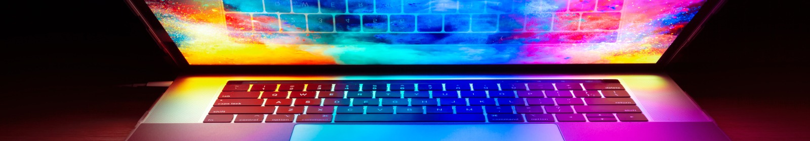 laptop with rainbow desktop background