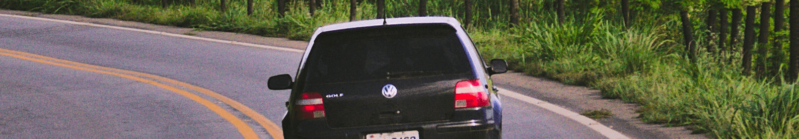 black car on winding road