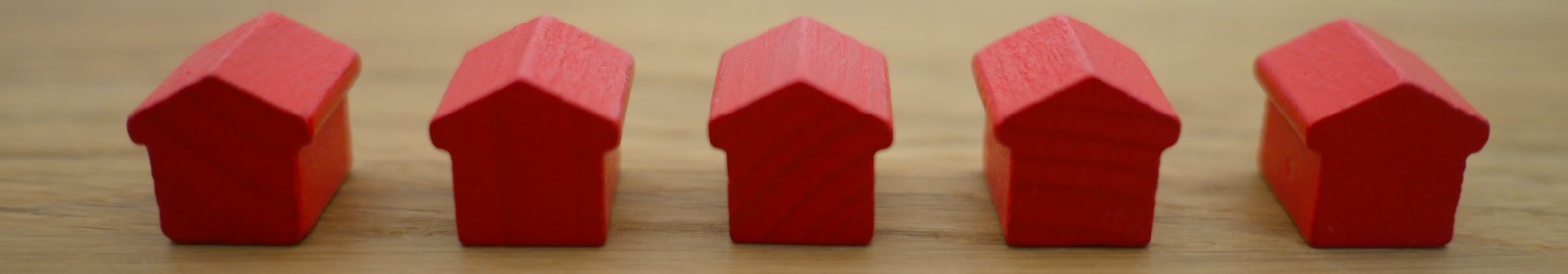 red monopoly houses on table