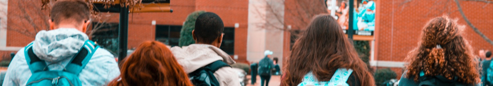 kids wearing backpacks walking to school