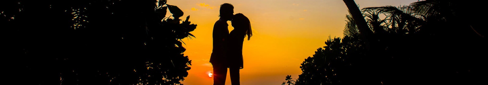 couple embracing with sunset