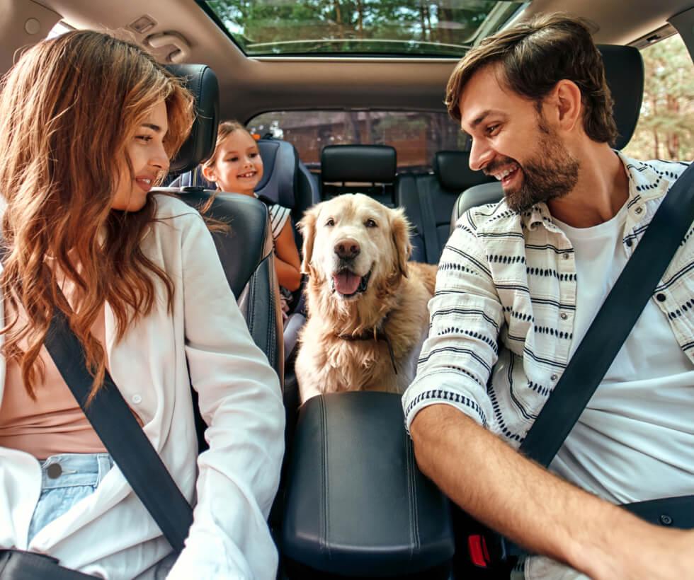 Family of three and dog in a car