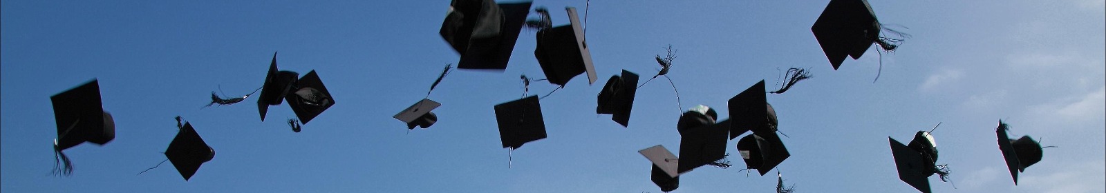 graduation caps thrown in air